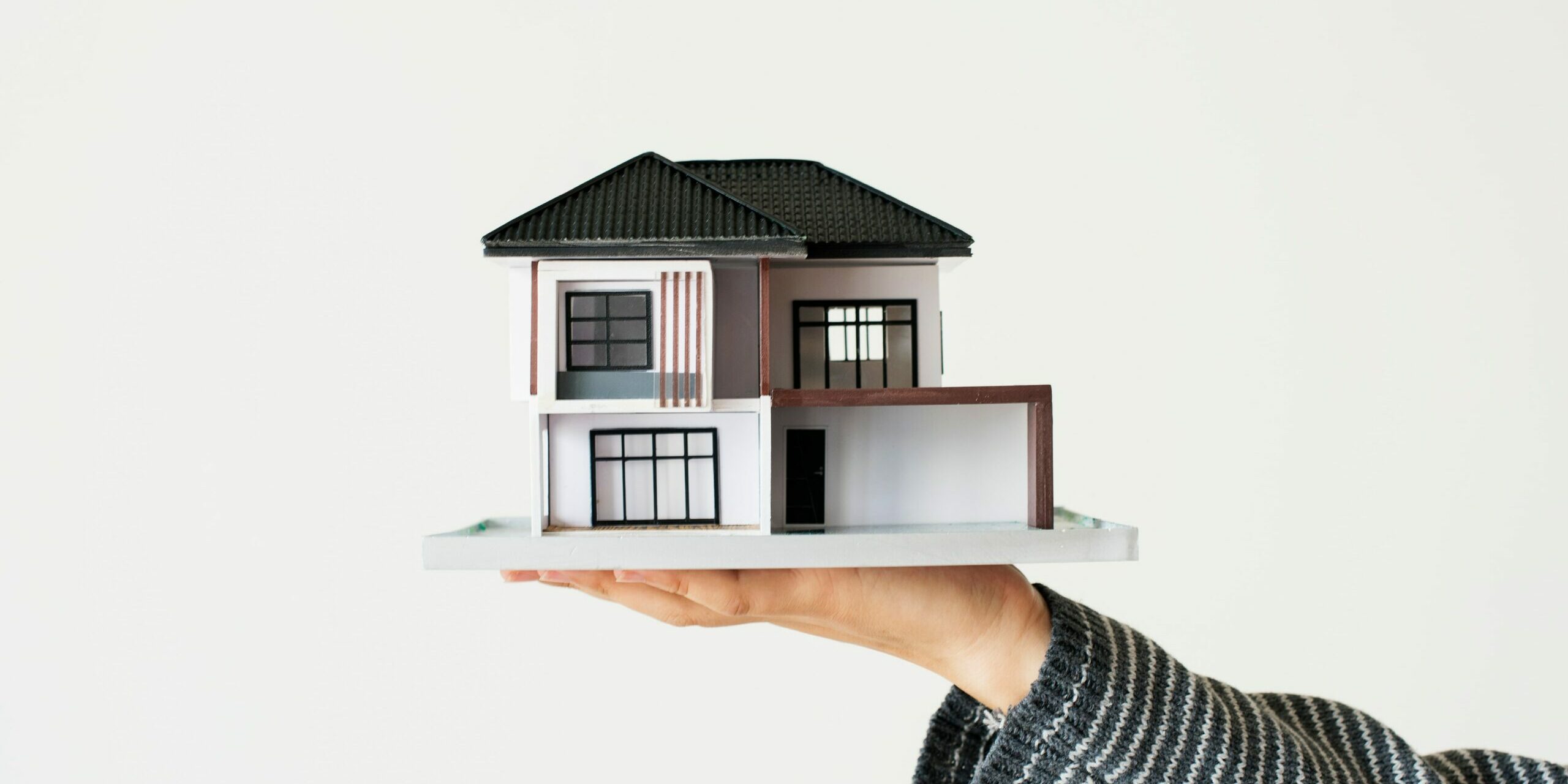 hand-presenting-model-house-for-home-loan-campaign-min HOME TO SELL