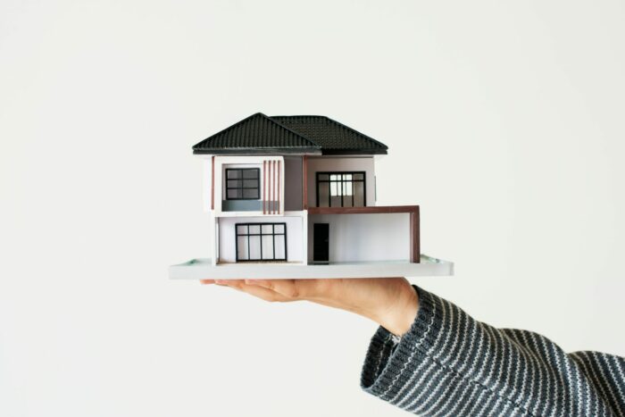hand-presenting-model-house-for-home-loan-campaign-min HOME TO SELL